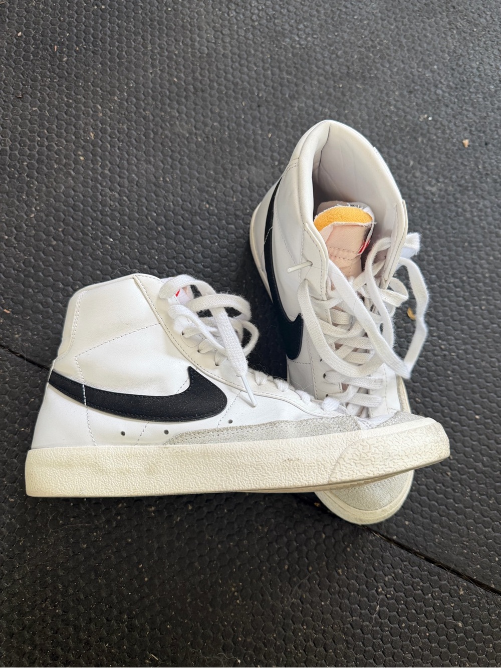 Nike White High-Top Sneakers with Black Swoosh and Yellow Tongue Accent